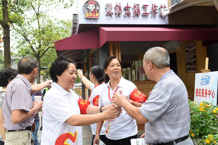 武林大媽黨員志愿者在微笑亭為游客指路并送上涼茶.jpg