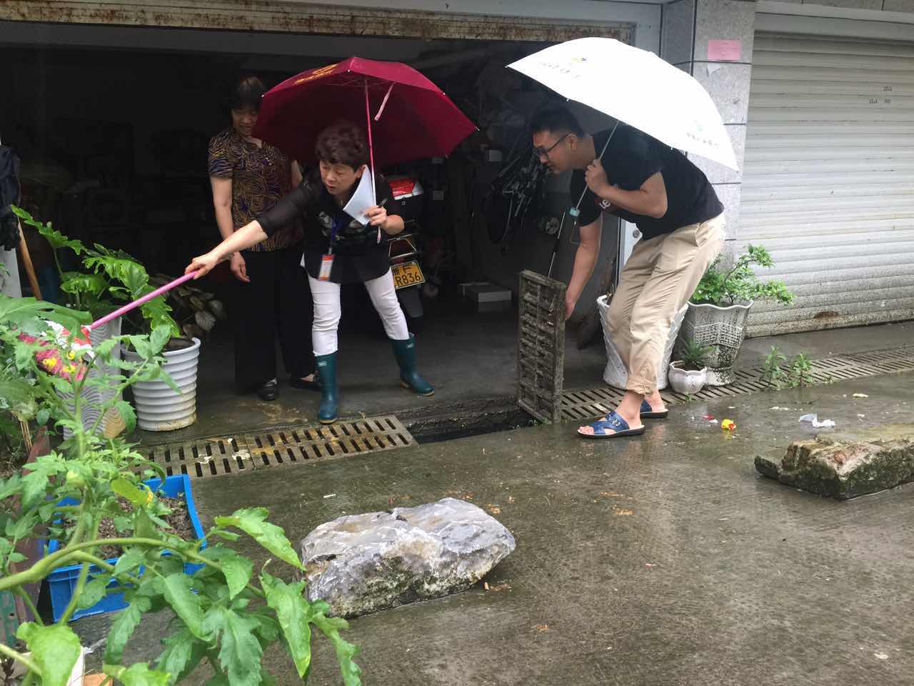 南門社區(qū)黨員樓道長(zhǎng)周羅以協(xié)調(diào)解決小區(qū)排水問題.JPG